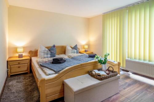 a bedroom with a large bed with blue pillows at Ferienhaus Kleine Auszeit in Bleicherode