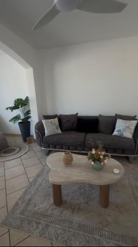 a living room with a couch and a coffee table at Une Parenthèse à 2 in Saint-Joseph