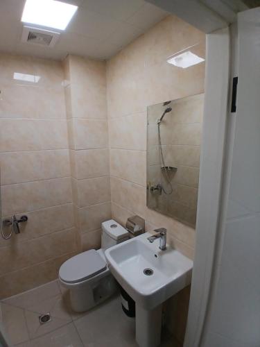 a bathroom with a toilet and a sink at Gandan Peace Guest House in Ulaanbaatar