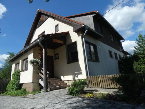 a white house with a gambrel roof at Forester Apartment Zuberec in Zuberec