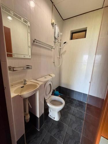 a bathroom with a toilet and a sink at Nazri's Place 2 in Tioman Island