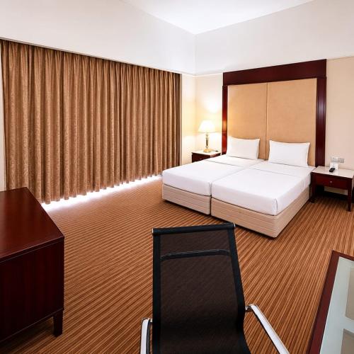 a large hotel room with a bed and a desk at Silka Maytower Kuala Lumpur in Kuala Lumpur