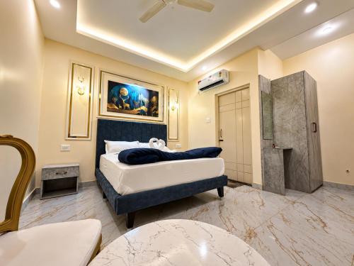 a bedroom with a king sized bed and a table at Hotel SR Vivanta,Brahmapur in Brahmapur