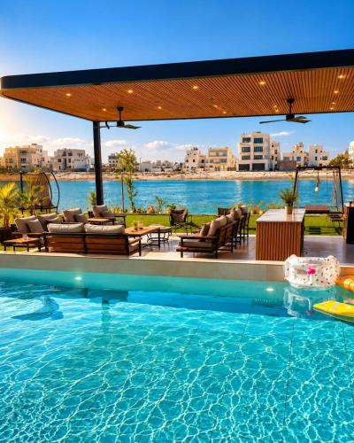 a swimming pool with a view of the water at Paradise in Al Khīrān