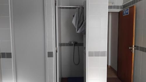 a shower in a bathroom with a glass door at CCCA Monte Loureiro in Raposeira