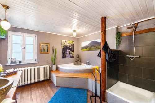a bathroom with a large tub and a sink at Heimat Liebe_Scialla in Herbolzheim