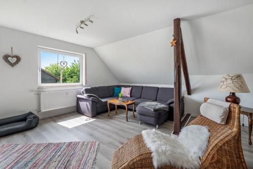 a living room with a couch and a window at Haus Schönblick in Amorbach