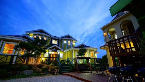 a large house with lights on in the yard at Buan lemon terrace pension in Buan