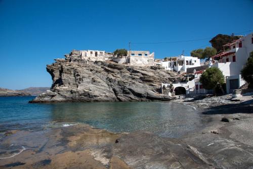 a group of buildings on top of a cliff next to the water at Aegean Whisper Koumelas in Mamádhos