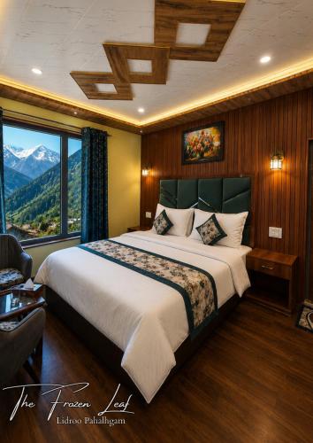 a bedroom with a large bed with a large window at The Frozen Leaf in Pahalgām