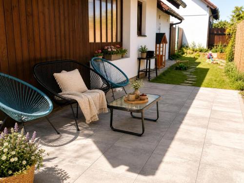 a patio with two chairs and a table on a patio at Playroom, 2 bdrooms, KRUMLOV 5 min by car, "Stone's throw Apartment" in Kájov