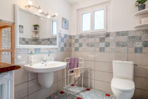 a white bathroom with a sink and a toilet at Gîte La Motette Drôme Provençale in Rousset-les-Vignes