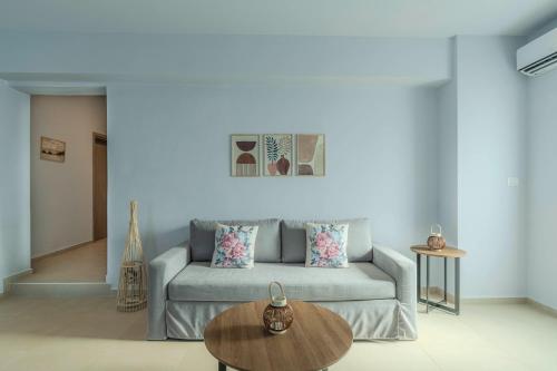 a living room with a couch and a table at Aspasia House in Platanias