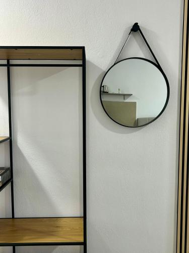 a mirror hanging on a wall next to a door at Salt & Sea in Sarti