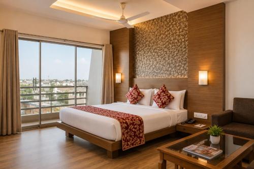 a hotel room with a bed and a large window at Landmark, Rewa - AM Hotel Kollection in Rewa