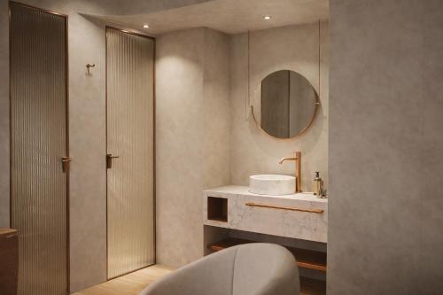 a bathroom with a sink and a mirror at Porto Antico in Chania