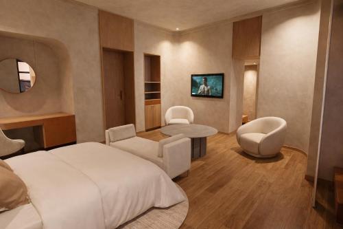 a hotel room with a bed and a table and chairs at Porto Antico in Chania