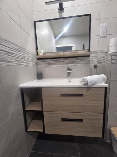 a bathroom with a sink and a mirror at Chambre Premium "Plume"- SDB privée & coin repas in Sainte-Geneviève-des-Bois