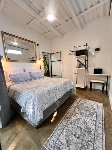 a bedroom with a bed and a desk at 16 st Johns - Studio 2 in Port Shepstone