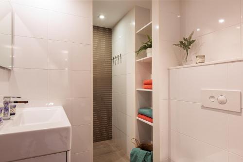 a white bathroom with a sink and a shower at Lets Holidays INCREDIBLE APARTMENT WITH AMAZING VIEWS in Tossa de Mar
