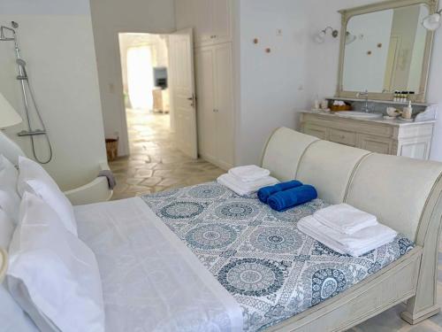 a bedroom with a bed with two towels and a mirror at Koundouros 186 View in Koundouros