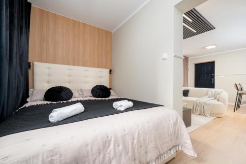 a bedroom with a large bed with two pillows on it at Aparthotel Cieplice in Jelenia Góra