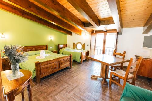a bedroom with two beds and a wooden ceiling at The Chalet, guest house in Agerola
