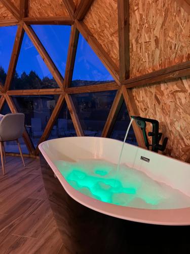 a bath tub in the middle of a room at El Molí Glamping Escapada Romántica in Adzaneta
