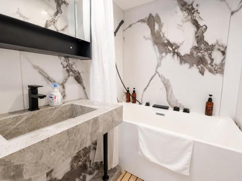a bathroom with a marble counter top and a sink at Zao Sunvalley Hotel in Yamagata