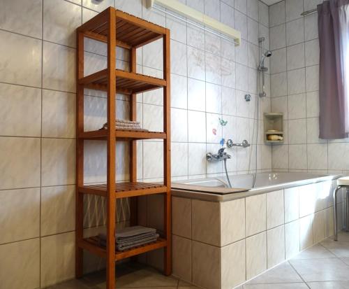 a bathroom with a towel rack next to a tub at Ferienwohnung Fam. Höhn in Kappel-Grafenhausen