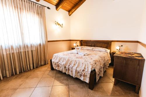 a bedroom with a bed and a large window at Agriturismo La Baita in Agerola