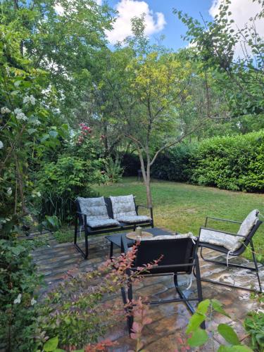 a patio with two chairs and a table in a yard at Avalon Mali Stapar in Mali Stapar