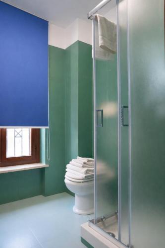 a bathroom with a toilet and a glass shower at Fiuggi Terme Bonifacio Apartment in Fiuggi