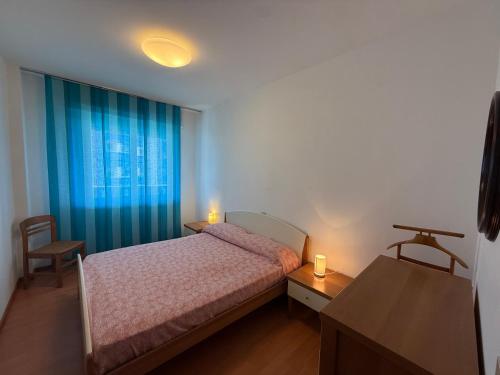 a bedroom with a bed and a window with two candles at Residence Luna in Lignano Sabbiadoro