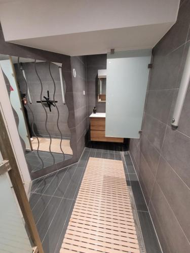 a bathroom with a walk in shower and a sink at Betting 2 in Merlebach