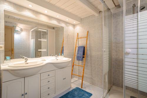 a bathroom with a sink and a mirror and a shower at Gite Romantique de Type Charentais in Le Thou
