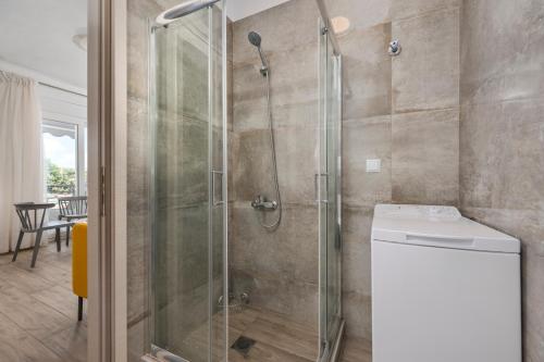 a shower with a glass door in a bathroom at SLV Danai 7 Apartments in Ofrínion