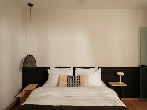 a bedroom with a large bed with white sheets and pillows at Nostos - Luxury Apartment in Agrinio in Agrinio