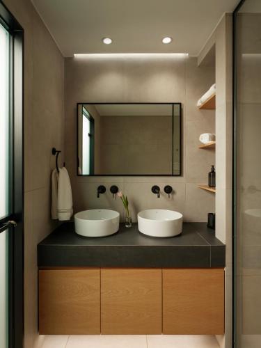 a bathroom with two sinks and a mirror at Nostos - Luxury Apartment in Agrinio in Agrinio