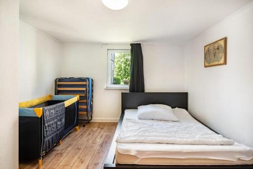 a small bedroom with a bed and a window at Haus Mersche in Gösenroth