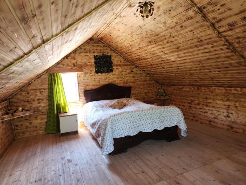 a bedroom in an attic with a bed in it at Teo's cottage in Maradidi