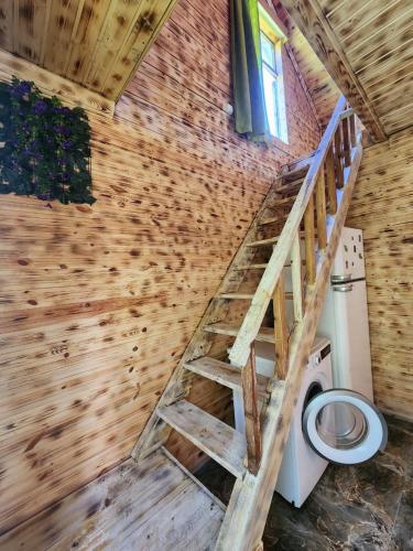 a bathroom with a staircase leading to a toilet at Teo's cottage in Maradidi