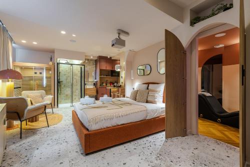 a bedroom with a large bed and a kitchen at Suite romantique Ibiza, Jacuzzi, Spa in Strasbourg