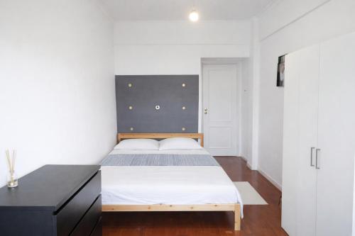 a bedroom with a large bed with a black headboard at Colombo Mall Room in Lisbon