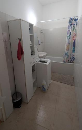 a bathroom with a sink and a toilet and a tub at B59 guesthouse in Budakalász