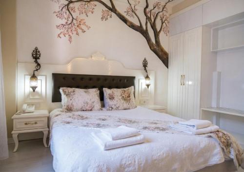 a bedroom with a bed with towels on it at Kaleiçi Ozkavak Hotel in Antalya