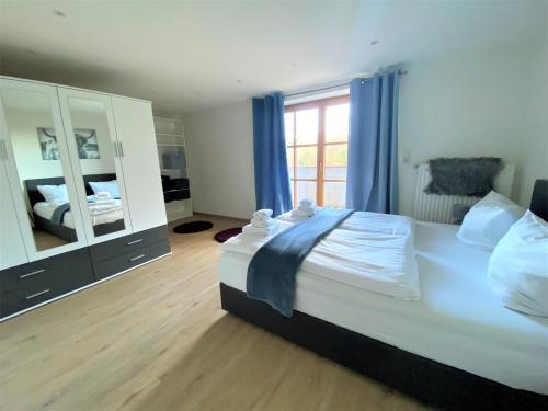 a bedroom with a large bed and a large mirror at Ferienwohnung Am Mühlbach 1 in Halblech