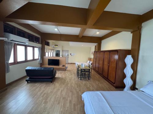 a bedroom with a bed and a living room at Sukstay Hotel in Bangkok