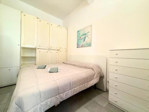 a bedroom with a bed and a dresser at DIMORA Concept - Yellow Apartment in Ceriale