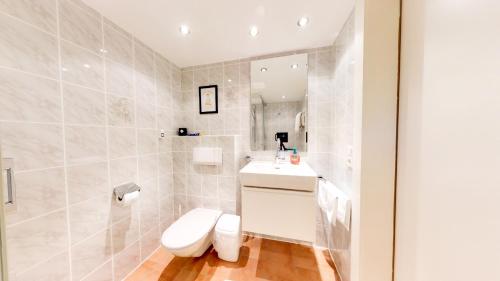 a white bathroom with a toilet and a sink at Wohnhaus Christoph in Längenfeld